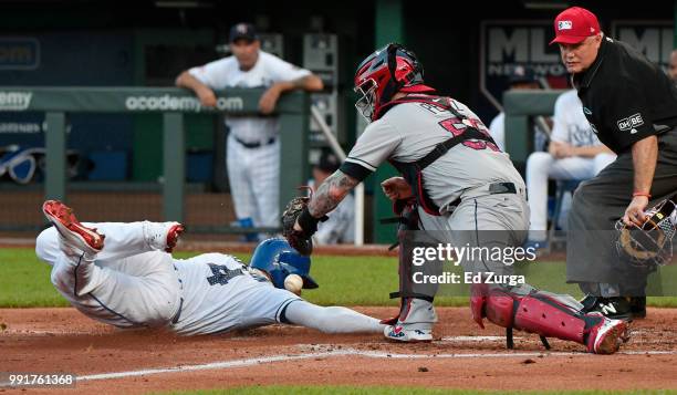 Alex Gordon of the Kansas City Royals steals home past Roberto Perez of the Cleveland Indians in the second inning at Kauffman Stadium on July 4,...