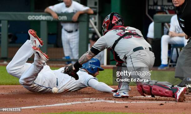Alex Gordon of the Kansas City Royals steals home past Roberto Perez of the Cleveland Indians in the second inning at Kauffman Stadium on July 4,...