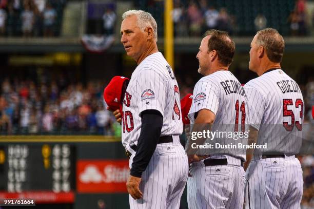 Bud Black of the Colorado Rockies removes his cap during the singing of the national anthem before a game against the San Francisco Giants at Coors...