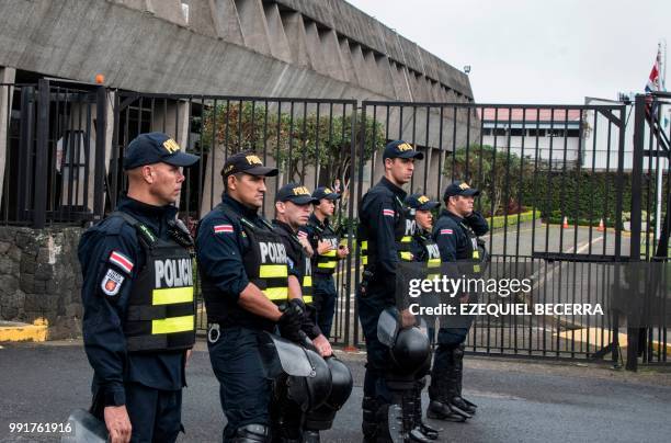 Police stand guard outside the presidential house in San Jose, on July 4 as taxi drivers protest against Uber for the second consecutive day.