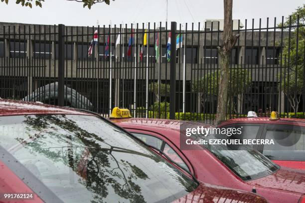 Taxis remain outside the presidential house in San Jose, on July 4 during a taxi drivers protest against Uber for the second consecutive day.