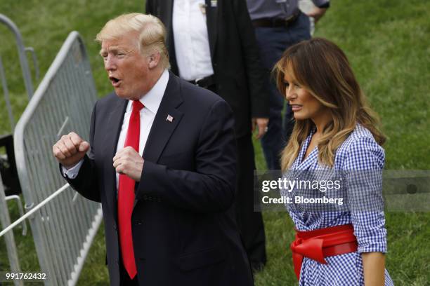President Donald Trump, left, speaks as First Lady Melania Trump looks on while greeting guests at a picnic for military families in Washington,...