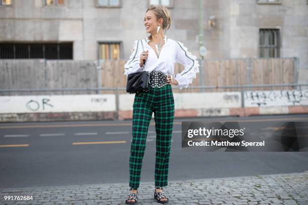 Caro Cult is seen attending Riani wearing green plaid pants with white shirt and studded black belt during the Berlin Fashion Week July 2018 on July...