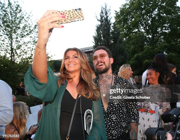 Farina Opoku and Marcel Ostertag take a selfie during the Marcel Ostertag show during the Berlin Fashion Week Spring/Summer 2019 at Westin Grand...