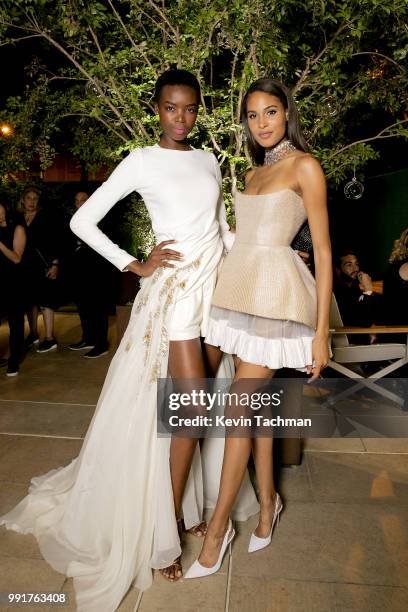 Maria Borges and Cindy Bruna attend the amfAR Paris Dinner at The Peninsula Hotel on July 4, 2018 in Paris, France.