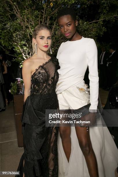 Caroline Daur and Maria Borges attend the amfAR Paris Dinner at The Peninsula Hotel on July 4, 2018 in Paris, France.