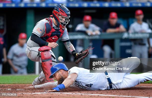 The Kansas City Royals' Alex Gordon scores as Cleveland Indians catcher Roberto Perez drops the throw on a steal of home plate in the second inning...