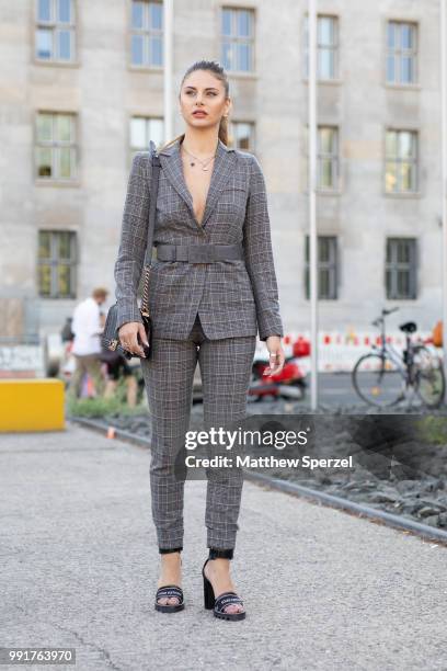 Carina Zavline is seen attending Riani wearing a grey suit during the Berlin Fashion Week July 2018 on July 4, 2018 in Berlin, Germany.