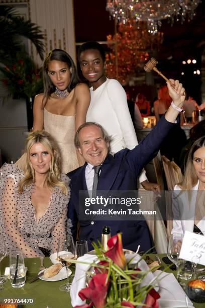 Cindy Bruna, Maria Borges, Nicky Hilton and Simon de Pury attend the amfAR Paris Dinner at The Peninsula Hotel on July 4, 2018 in Paris, France.