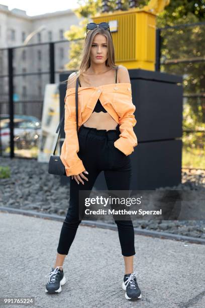 Neele Bronst is seen attending RIANI wearing a styled orange jacket with black pants during the Berlin Fashion Week July 2018 on July 4, 2018 in...