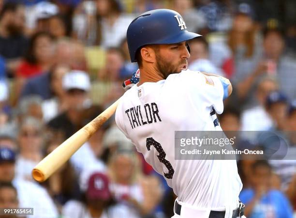 Chris Taylor of the Los Angeles Dodgers singles in a run in the third inning of the game against the Pittsburgh Pirates at Dodger Stadium on July 4,...