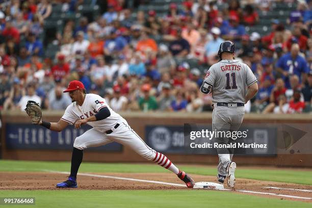 Ronald Guzman of the Texas Rangers makes the out against Evan Gattis of the Houston Astros at Globe Life Park in Arlington on July 4, 2018 in...