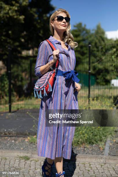 Tanja Buelter is seen attending Maison Common wearing purple dress with blue belt and heels during the Berlin Fashion Week July 2018 on July 4, 2018...