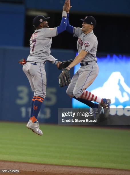 New York Mets shortstop Jose Reyes and Brandon Nimmo celebrate the win as the Toronto Blue Jays fall to the New York Mets 6-3 at the Rogers Centre in...