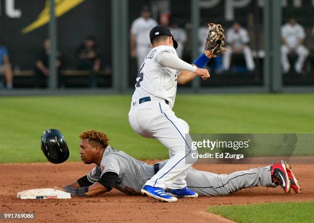 Jose Ramirez of the Cleveland Indians steals second base past Whit Merrifield of the Kansas City Royals in the fifth inning at Kauffman Stadium on...