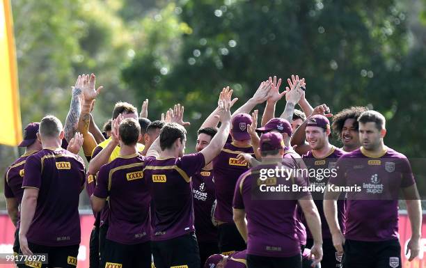 The Queensland team high five each other during a Queensland Maroons State of Origin training session at Sanctuary Cove on July 5, 2018 in Gold...