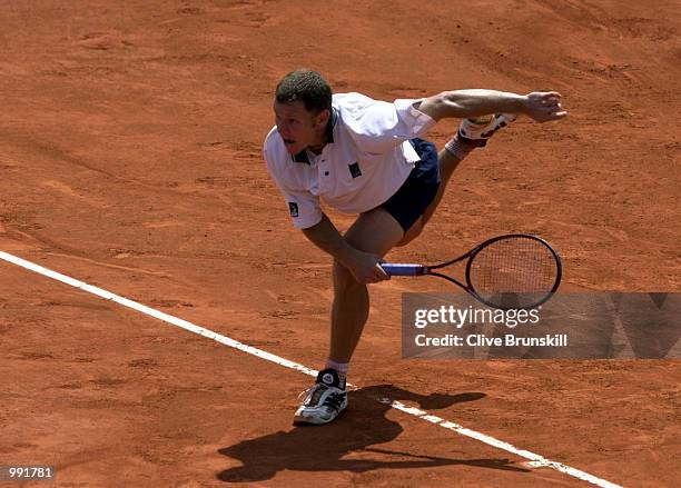 Michael Russell of the USA serves in his fourth round match against Gustavo Kuerten of Brazil during the French Open Tennis at Roland Garros, Paris,...