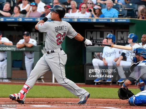 Michael Brantley of the Cleveland Indians hits an RBI double in the first inning against the Kansas City Royals at Kauffman Stadium on July 4, 2018...
