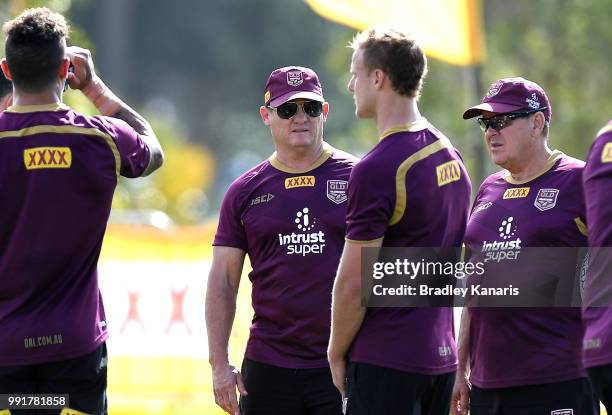 Coach Kevin Walters chats with Daly Cherry-Evans during a Queensland Maroons State of Origin training session at Sanctuary Cove on July 5, 2018 in...