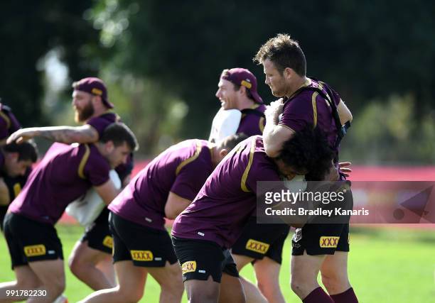 Felise Kaufusi and team mates run through a defense drill during a Queensland Maroons State of Origin training session at Sanctuary Cove on July 5,...