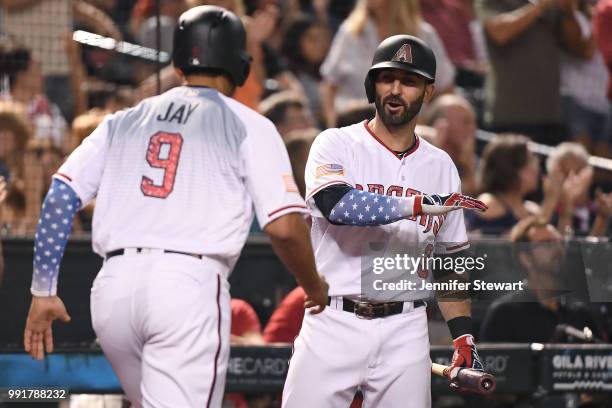 Daniel Descalso of the Arizona Diamondbacks congratulates Jon Jay after scoring in the fourth inning of the MLB game against the St. Louis Cardinals...