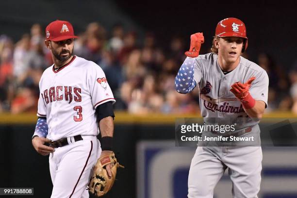 Harrison Bader of the St. Louis Cardinals celebrates a double in front of Daniel Descalso of the Arizona Diamondbacks in the fourth inning of the MLB...
