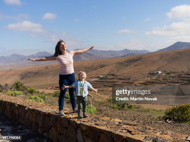 mother with son smiling at sun - child eyes closed stock pictures, royalty-free photos & images