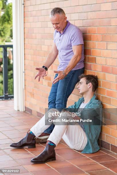 dad giving son a dressing down - androgynous boys stock pictures, royalty-free photos & images