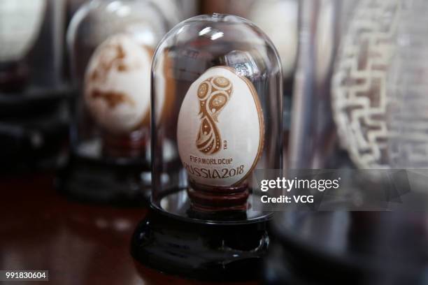 The official emblem of the 2018 FIFA World Cup is seen on an eggshell at Zeng Huosheng's house on June 26, 2018 in Hangzhou, Zhejiang Province of...