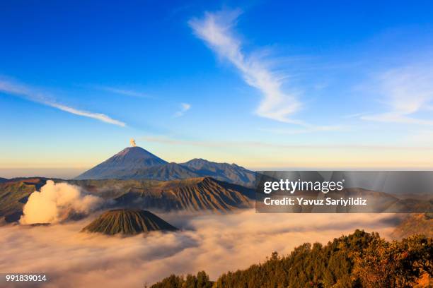 mt.bromo,mt.semeru,mt.batok covered with fog and sulfur gas. - mt semeru stock-fotos und bilder