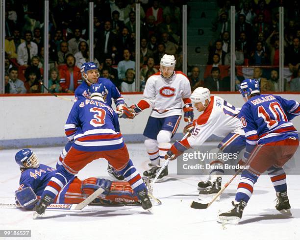 Bobby Smith of the Montreal Canadiens skates against James Patrick and Kelly Miller of the New yrk Rangers during the 1980's at the Montreal Forum in...