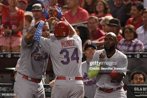 Yairo Munoz of the St. Louis Cardinals is celebrates a solo home run with Yadier Molina in the seventh inning of the MLB game against the Arizona...