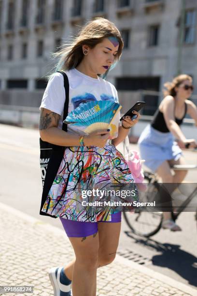 Guest is seen attending Rebekka Ruetz wearing a multi-color skirt with purple spandex shorts during the Berlin Fashion Week July 2018 on July 4, 2018...