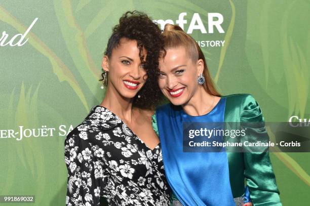 Models Noemie Lenoir and Petra Nemcova attend the amfAR Paris Dinner 2018 at The Peninsula Hotel on July 4, 2018 in Paris, France.