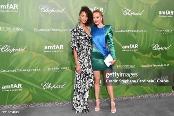 Models Noemie Lenoir and Petra Nemcova attend the amfAR Paris Dinner 2018 at The Peninsula Hotel on July 4, 2018 in Paris, France.