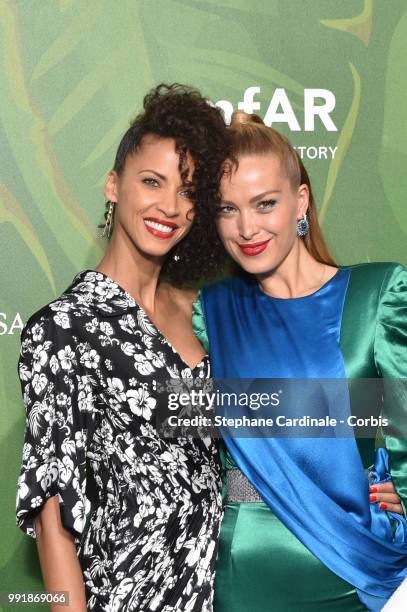 Models Noemie Lenoir and Petra Nemcova attend the amfAR Paris Dinner 2018 at The Peninsula Hotel on July 4, 2018 in Paris, France.