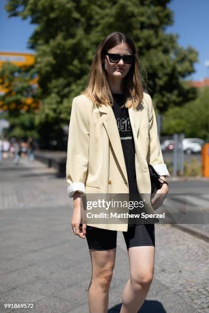 Guest is seen attending Rebekka Ruetz wearing a light yellow blazer with black shirt and spandex shorts during the Berlin Fashion Week July 2018 on...