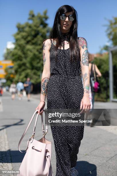 Guest is seen attending Rebekka Ruetz wearing a black/white pattern jumper during the Berlin Fashion Week July 2018 on July 4, 2018 in Berlin,...