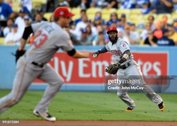 Josh Harrison of the Pittsburgh Pirates makes a throw to first base in the third inning against the Los Angeles Dodgers at Dodger Stadium on July 2,...