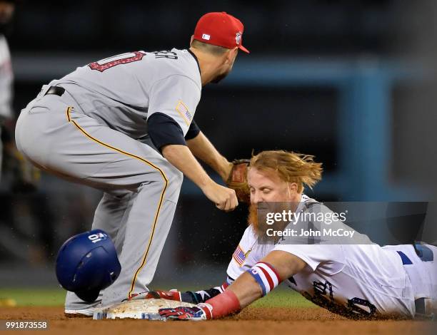 Justin Turner of the Los Angeles Dodgers is safe at second on a double when Jordy Mercer of the Pittsburgh Pirates gets the throw late in the fourth...