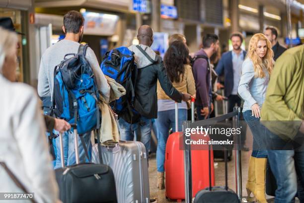business people standing in queue at airport - long hair stock pictures, royalty-free photos & images