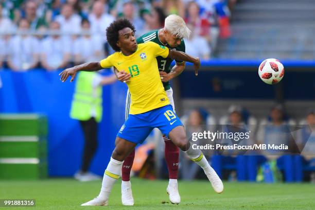 Willian of Brazil and Carlos Salcedo of Mexico competes for the ball during the 2018 FIFA World Cup Russia Round of 16 match between Brazil and...