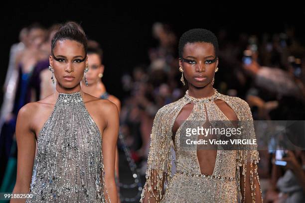 Cindy Bruna and a model walk the runway during the Georges Hobeika Haute Couture Fall Winter 2018/2019 fashion show as part of Paris Fashion Week on...