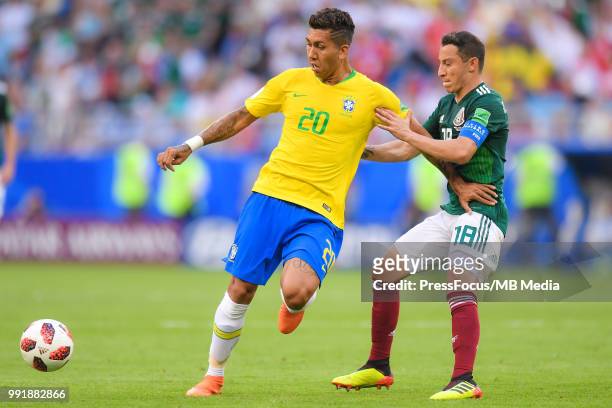 Roberto Firmino of Brazil competes with Andres Guardado of Mexico during the 2018 FIFA World Cup Russia Round of 16 match between Brazil and Mexico...