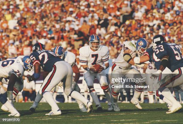 John Elway, Quarterback for the Denver Broncos prepares to hand the ball off during the National Football League Super Bowl XXI game against the...