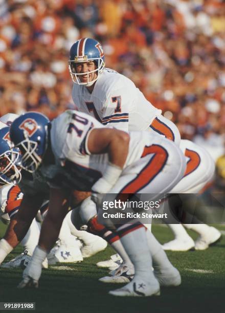 John Elway, Quarterback for the Denver Broncos calls the play on the line of scrimmage during the American Football Conference Championship game...