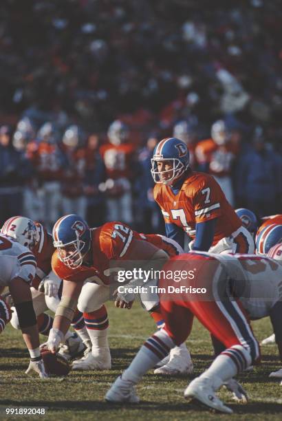 John Elway, Quarterback for the Denver Broncos calls the play on the line of scrimmage during the American Football Conference West game against the...