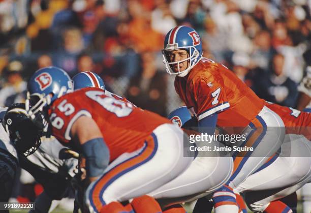John Elway, Quarterback for the Denver Broncos calls the play on the line of scrimmage during the American Football Conference West game against the...