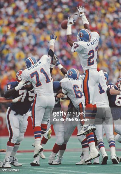 Steve Atwater, Full Safety and Greg Kragen Nose Tackle for the Denver Broncos jump to block a play against the Buffalo Bills during their American...
