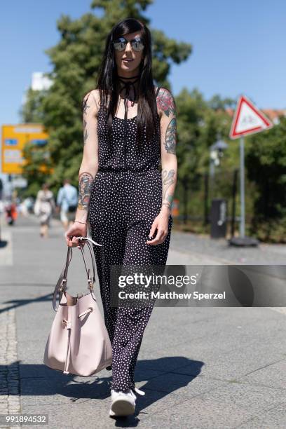 Guest is seen attending Rebekka Ruetz wearing a black/white pattern jumper during the Berlin Fashion Week July 2018 on July 4, 2018 in Berlin,...